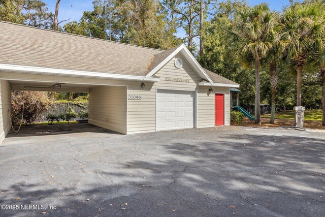 30936 Paradise Commons Unit 221, Fernandina Beach, FL 32034 - garage featuring aphalt driveway