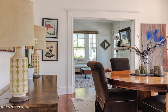 dining area featuring baseboards and wood finished floors