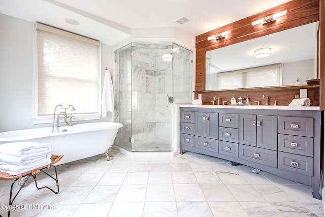 bathroom featuring double vanity, marble finish floor, a freestanding tub, a shower stall, and a sink