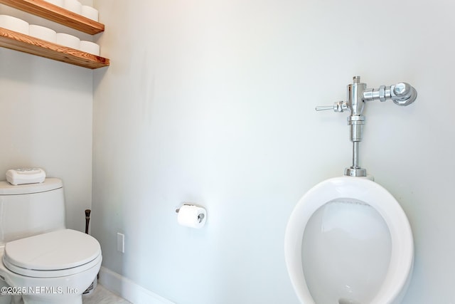bathroom with baseboards and toilet