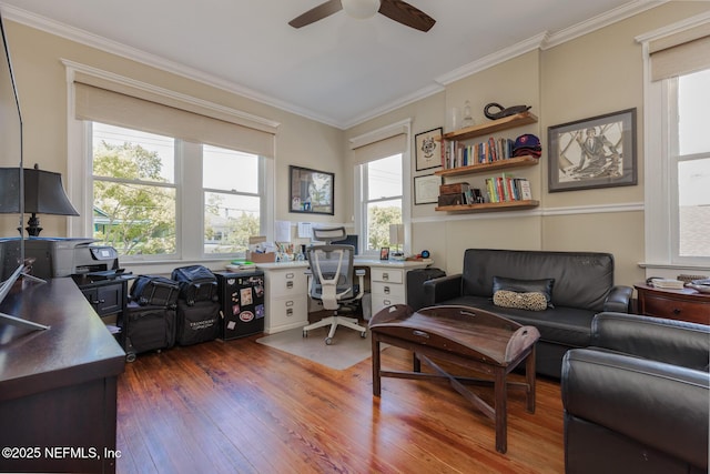 interior space with crown molding, a ceiling fan, wood finished floors, and built in shelves