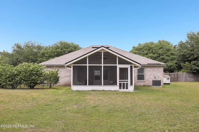 11009 Fawnwood Ct, Bryceville, FL 32009 - back of property with a lawn, fence, brick siding, and a sunroom