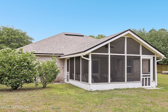 11009 Fawnwood Ct, Bryceville, FL 32009 - back of property with a lawn, a shingled roof, brick siding, and a sunroom