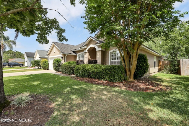 716 Hazelmoor Ln, Ponte Vedra, FL 32081 - view of front of house with an attached garage, stucco siding, a front yard, and fence