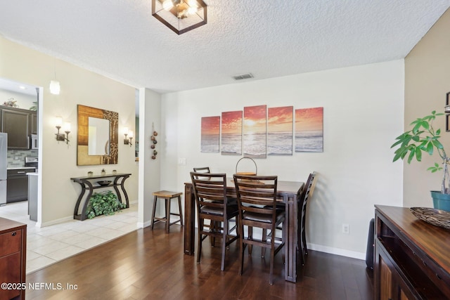 716 Hazelmoor Ln, Ponte Vedra, FL 32081 - dining area featuring a textured ceiling, baseboards, wood finished floors, and visible vents