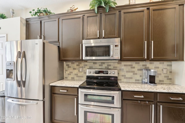 716 Hazelmoor Ln, Ponte Vedra, FL 32081 - kitchen with stainless steel appliances, dark brown cabinets, light stone counters, and tasteful backsplash