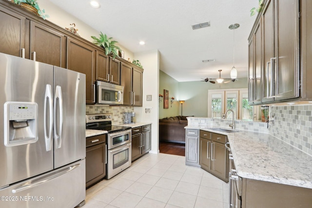 716 Hazelmoor Ln, Ponte Vedra, FL 32081 - kitchen featuring backsplash, visible vents, a sink, light tile patterned floors, and stainless steel appliances
