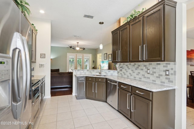 716 Hazelmoor Ln, Ponte Vedra, FL 32081 - kitchen with visible vents, a sink, light tile patterned floors, a peninsula, and stainless steel appliances