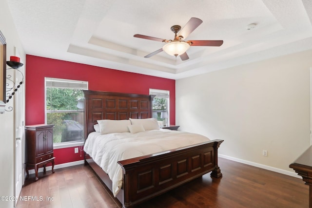 716 Hazelmoor Ln, Ponte Vedra, FL 32081 - bedroom with baseboards, multiple windows, wood finished floors, and a raised ceiling