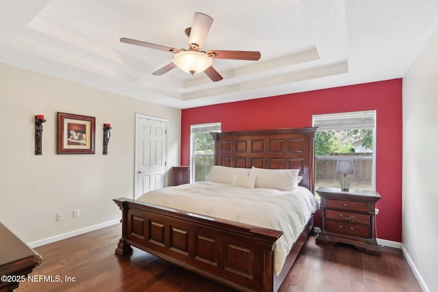 716 Hazelmoor Ln, Ponte Vedra, FL 32081 - bedroom with a ceiling fan, a tray ceiling, dark wood finished floors, and baseboards