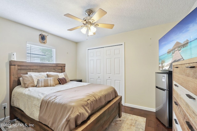 716 Hazelmoor Ln, Ponte Vedra, FL 32081 - bedroom with a closet, freestanding refrigerator, dark wood-style flooring, baseboards, and a ceiling fan