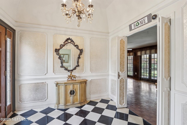 corridor with tile patterned floors, an inviting chandelier, and a decorative wall