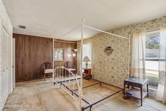 bedroom featuring visible vents, carpet floors, multiple windows, and wallpapered walls