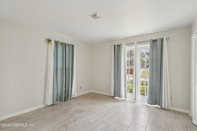 unfurnished room featuring baseboards