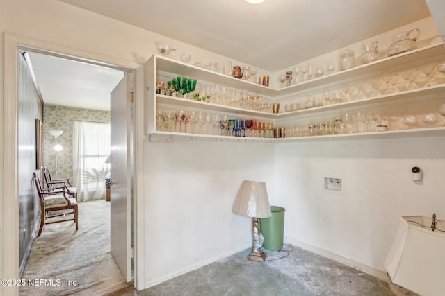 interior space featuring hookup for a washing machine, laundry area, and baseboards