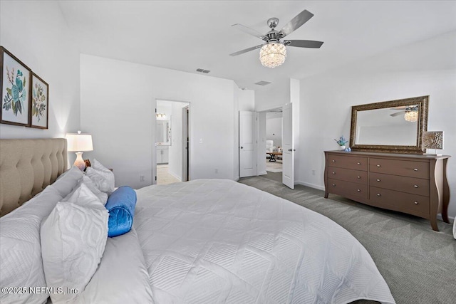 carpeted bedroom with ensuite bath, a ceiling fan, visible vents, and baseboards