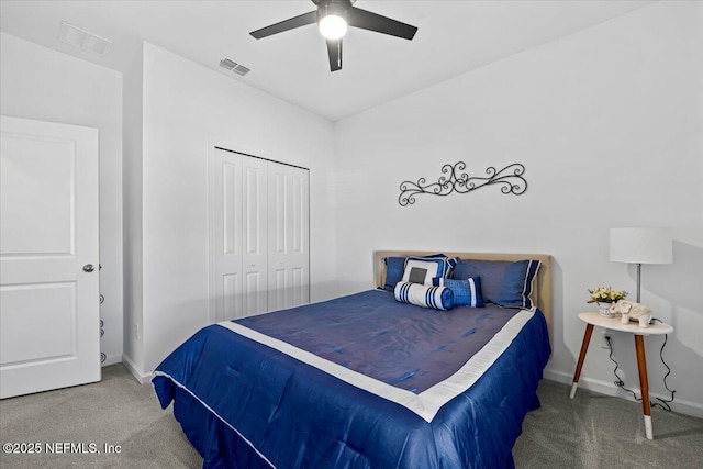 bedroom with a closet, carpet, visible vents, and baseboards
