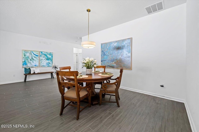 dining area with visible vents, baseboards, and dark wood-style flooring