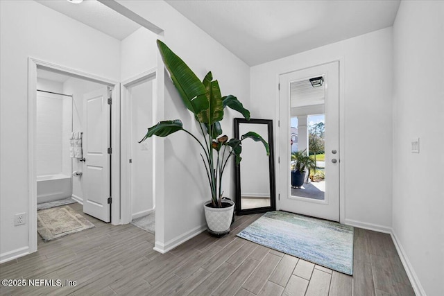 entrance foyer with wood finished floors and baseboards