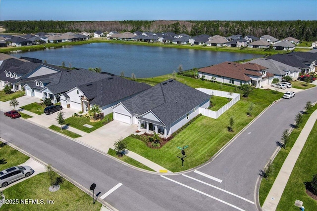 drone / aerial view featuring a residential view and a water view