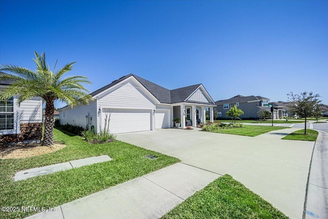 ranch-style home with concrete driveway, a front yard, and a garage