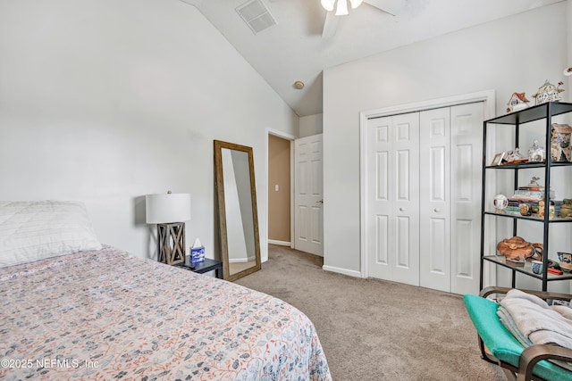 carpeted bedroom with a closet, ceiling fan, baseboards, visible vents, and lofted ceiling