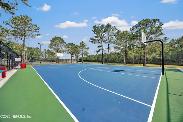 view of basketball court with community basketball court and fence