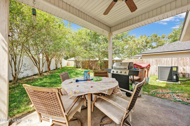 view of patio with cooling unit, outdoor dining space, grilling area, a ceiling fan, and a fenced backyard