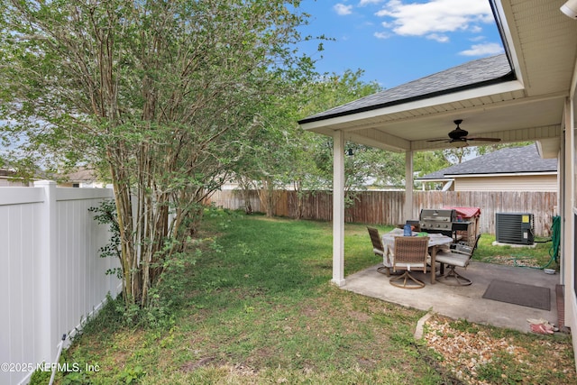 view of yard featuring cooling unit, a ceiling fan, a patio, and a fenced backyard