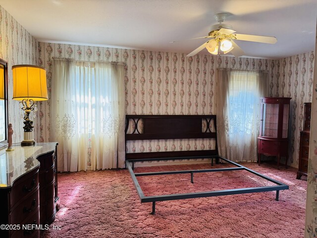 3715 Rustic Ln, Jacksonville, FL 32217 - carpeted bedroom with wallpapered walls and ceiling fan