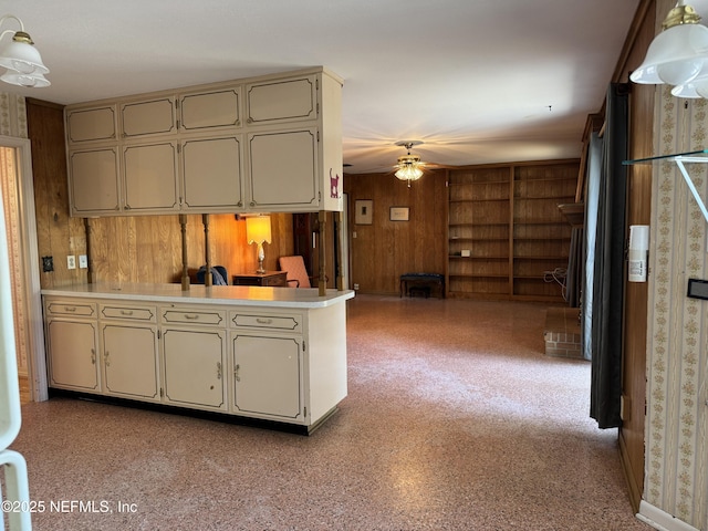 3715 Rustic Ln, Jacksonville, FL 32217 - kitchen with wood walls, a ceiling fan, a peninsula, light countertops, and open floor plan