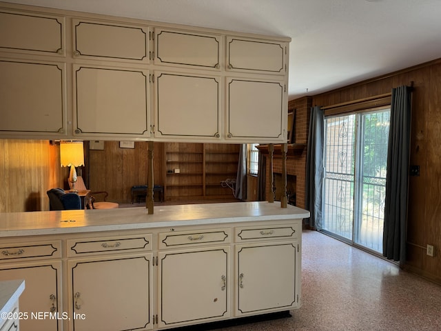 3715 Rustic Ln, Jacksonville, FL 32217 - kitchen featuring wood walls, light countertops, and white cabinets