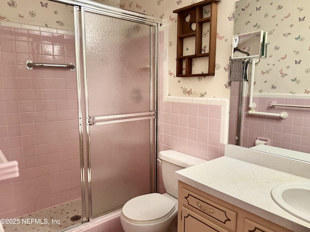 3715 Rustic Ln, Jacksonville, FL 32217 - bathroom with wallpapered walls, a shower stall, a wainscoted wall, toilet, and vanity