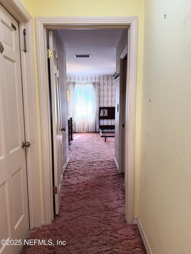 3715 Rustic Ln, Jacksonville, FL 32217 - corridor featuring carpet, wallpapered walls, and baseboards