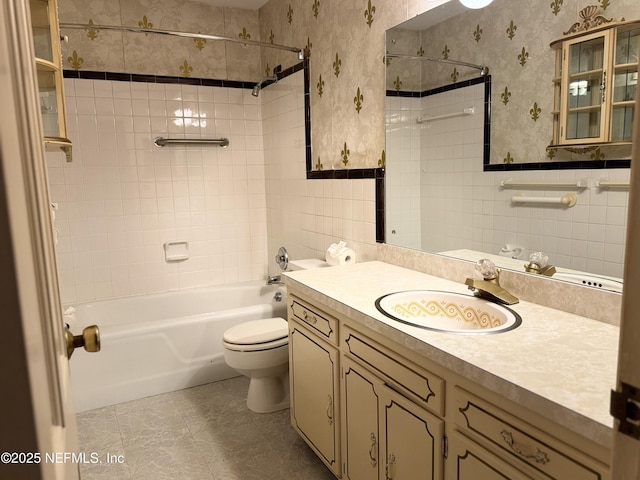 3715 Rustic Ln, Jacksonville, FL 32217 - full bathroom featuring tile walls, toilet, bathing tub / shower combination, wallpapered walls, and vanity