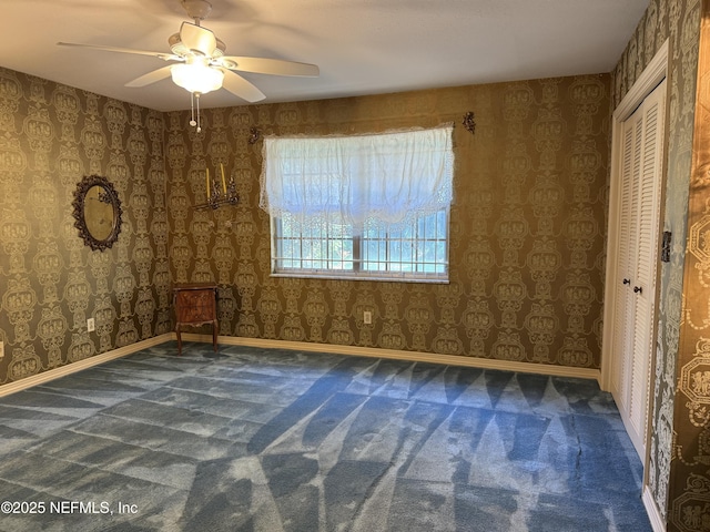 3715 Rustic Ln, Jacksonville, FL 32217 - unfurnished bedroom with carpet flooring, a ceiling fan, a closet, and wallpapered walls