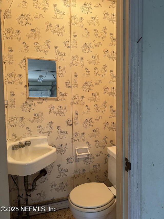 3715 Rustic Ln, Jacksonville, FL 32217 - half bath featuring toilet, a sink, and wallpapered walls