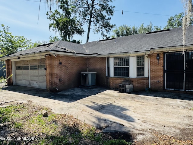 3715 Rustic Ln, Jacksonville, FL 32217 - view of front of house with brick siding, an attached garage, driveway, and central AC unit