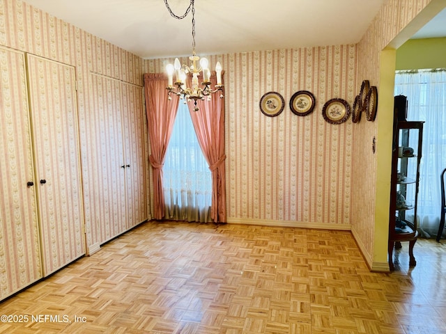 3715 Rustic Ln, Jacksonville, FL 32217 - unfurnished dining area with wallpapered walls, a chandelier, baseboards, and plenty of natural light