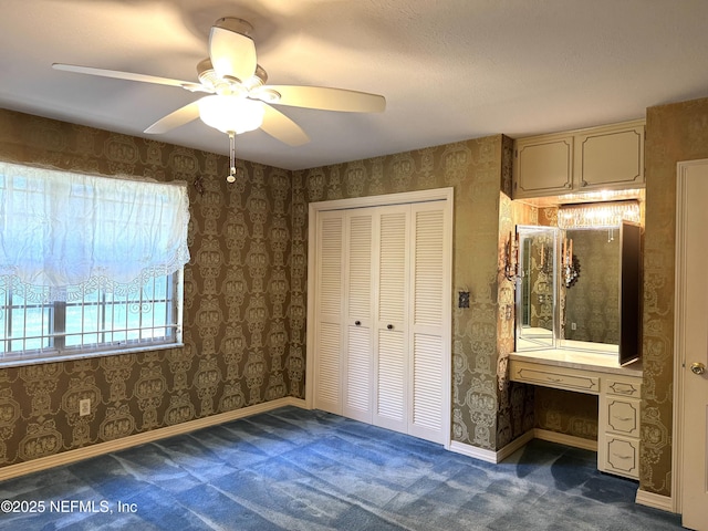 3715 Rustic Ln, Jacksonville, FL 32217 - unfurnished bedroom with carpet flooring, a closet, ceiling fan, and wallpapered walls