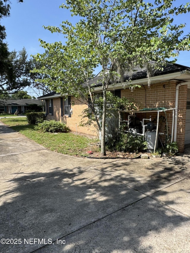 3715 Rustic Ln, Jacksonville, FL 32217 - view of front of property featuring brick siding, concrete driveway, and a garage