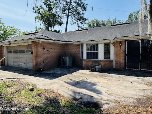 3715 Rustic Ln, Jacksonville, FL 32217 - view of front of home featuring brick siding, an attached garage, driveway, and central AC