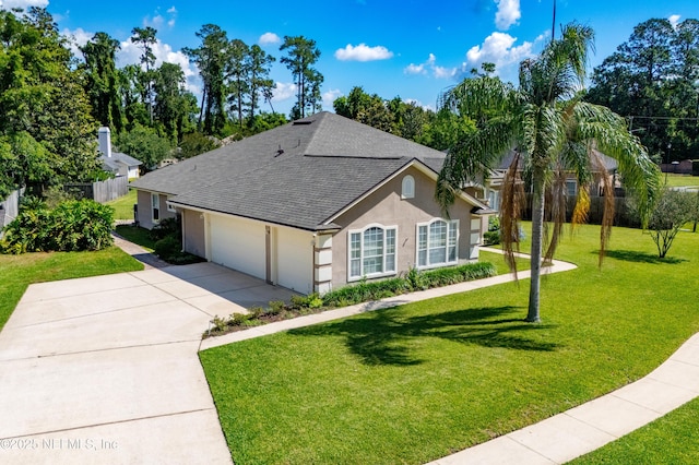 3099 Five Oaks Ln, Green Cove Springs, FL 32043 - view of front of house with a shingled roof, concrete driveway, stucco siding, and a garage