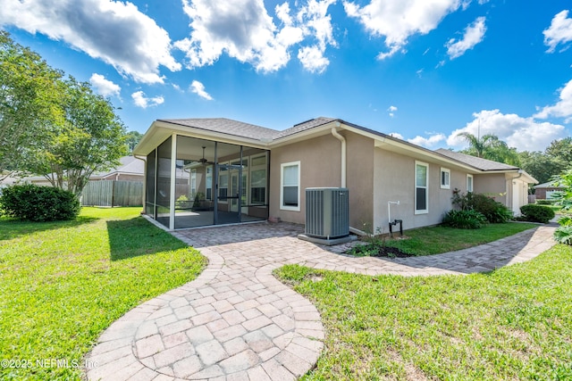 3099 Five Oaks Ln, Green Cove Springs, FL 32043 - rear view of house featuring a sunroom, central AC unit, a ceiling fan, stucco siding, and a patio