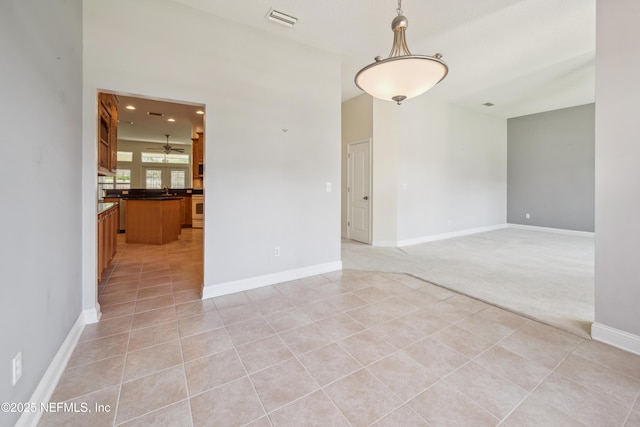 3099 Five Oaks Ln, Green Cove Springs, FL 32043 - empty room with light tile patterned floors, baseboards, and light carpet