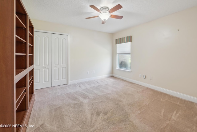 3099 Five Oaks Ln, Green Cove Springs, FL 32043 - unfurnished bedroom with carpet, a closet, a textured ceiling, baseboards, and ceiling fan