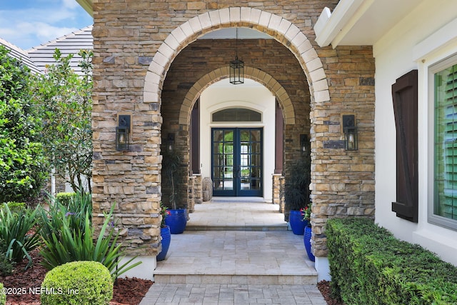 doorway to property with french doors and stone siding