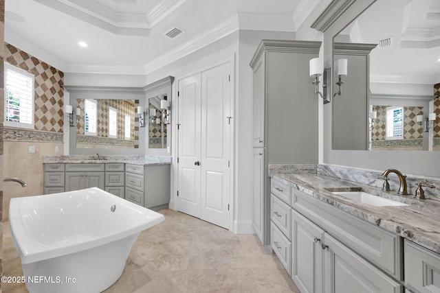 full bathroom with a sink, ornamental molding, and visible vents