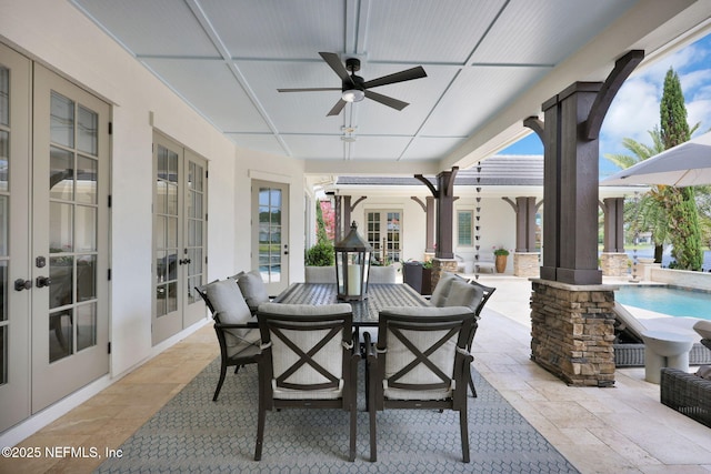 view of patio with french doors, outdoor dining area, ceiling fan, and an outdoor pool