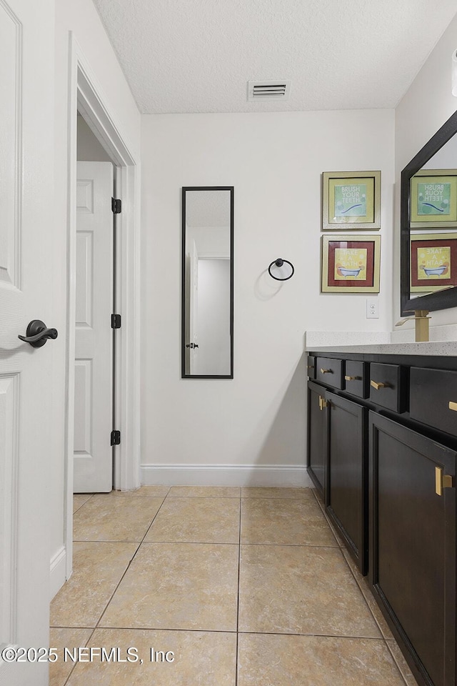 206 Woodland Greens Dr, Ponte Vedra, FL 32081 - bathroom with tile patterned floors, visible vents, vanity, baseboards, and a textured ceiling